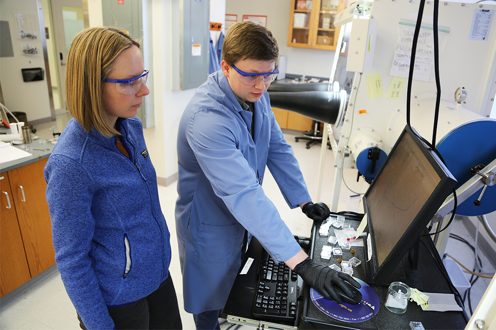Veronica Augustyn, left, looks on as a research assistant explains test results on a computer.