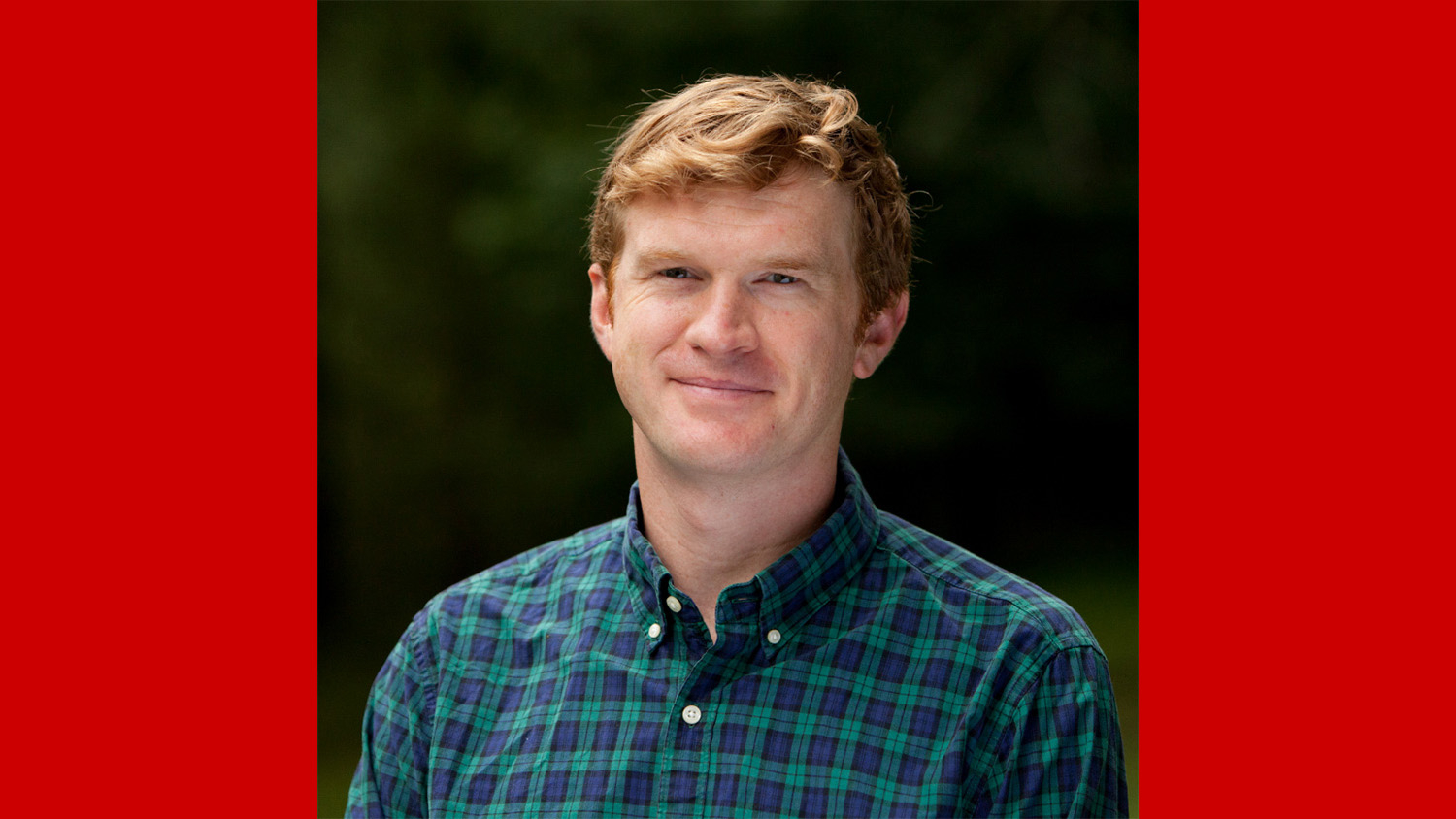 a man wearing a blue and green checked shirt