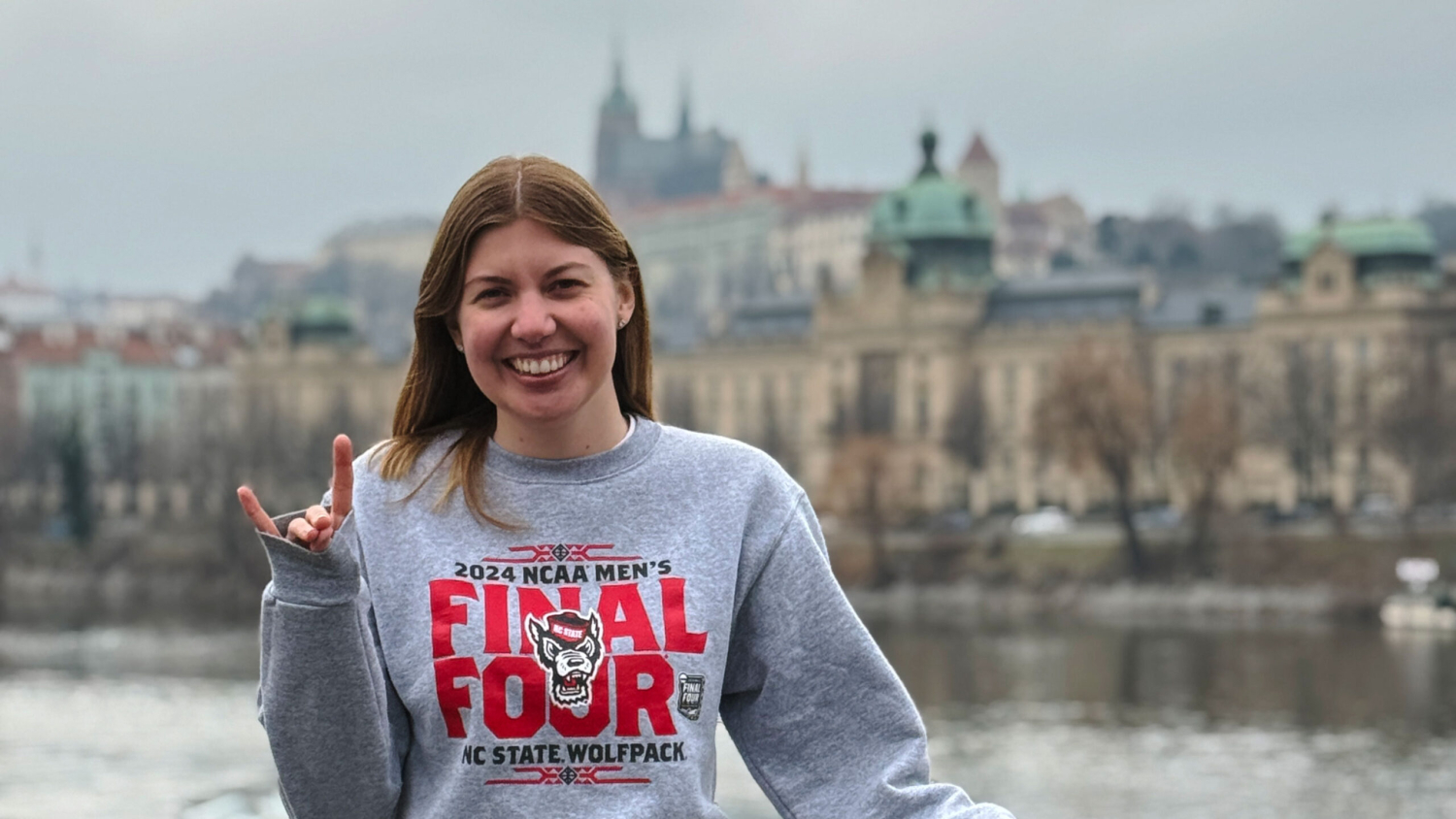 Kalena doing the wolfpack sign with Prague castle in the background.