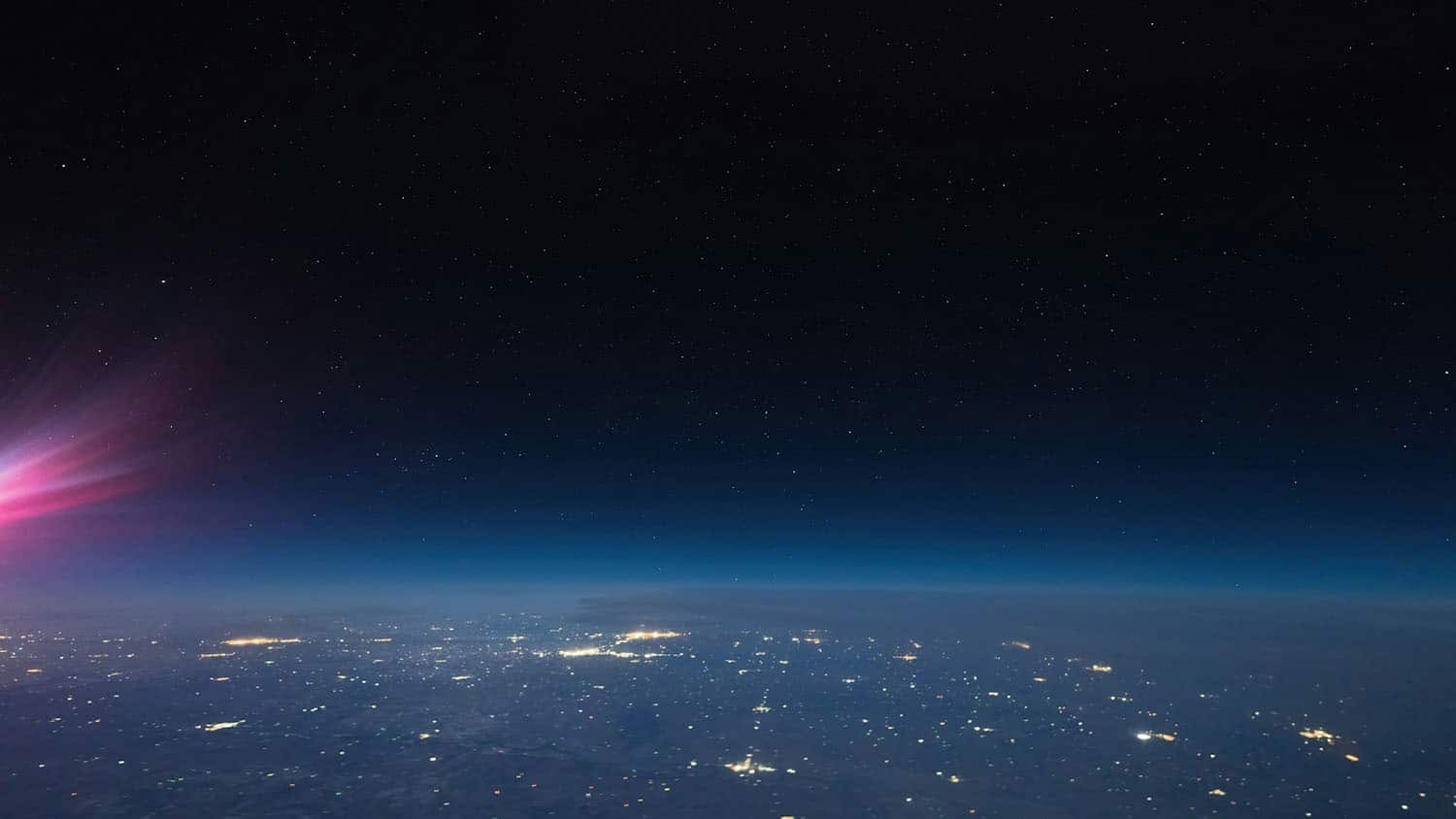 Aerial image shows cities as a pattern of lights sprawling across a wide area