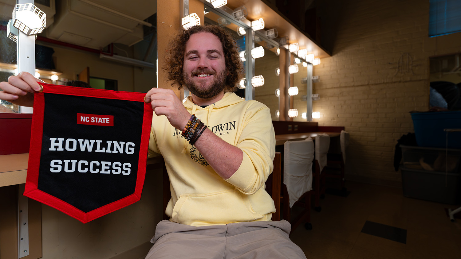 Brayden Hearn proudly displays his Howling Success banner in one of University Theatre's dressing rooms.