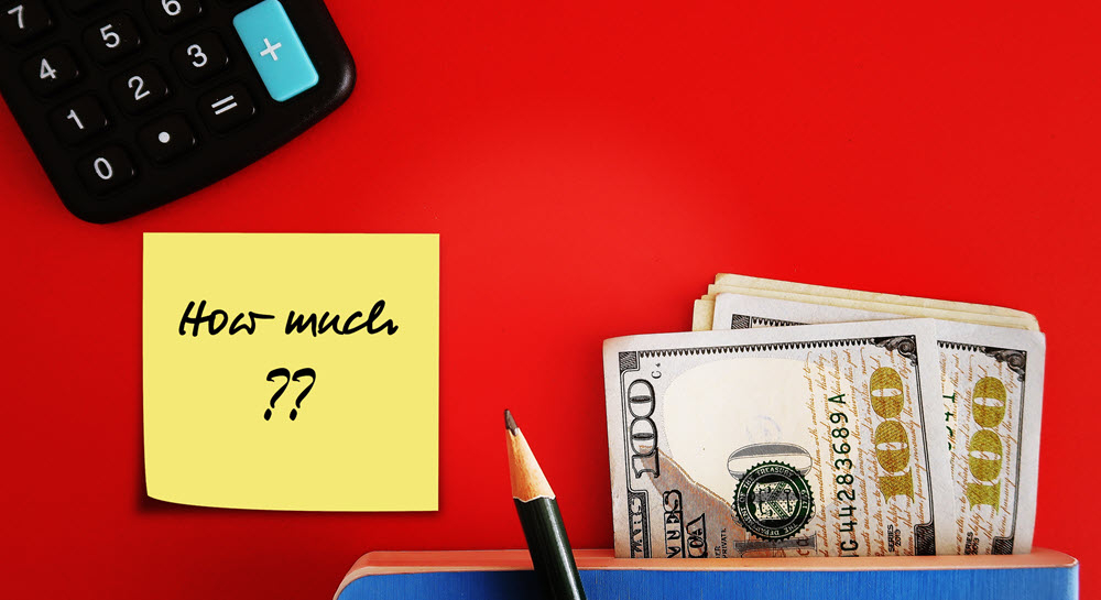 Calculator, US dollars and post it note that says "How much"?"