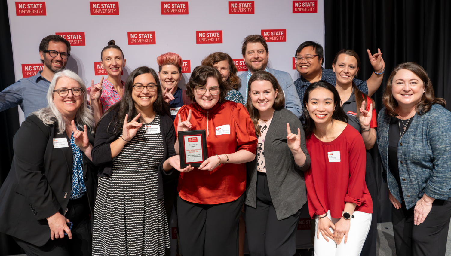 The Office of International Services poses with their award and the Vice Provost of Global Engagement, Amy Conger.
