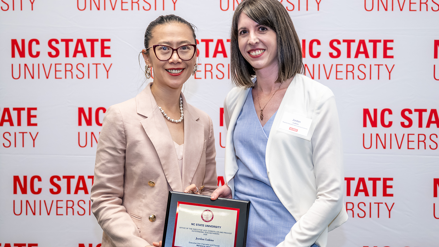 Assistant Teaching Professor Jordan Lukins poses with her Outstanding Teaching Award.