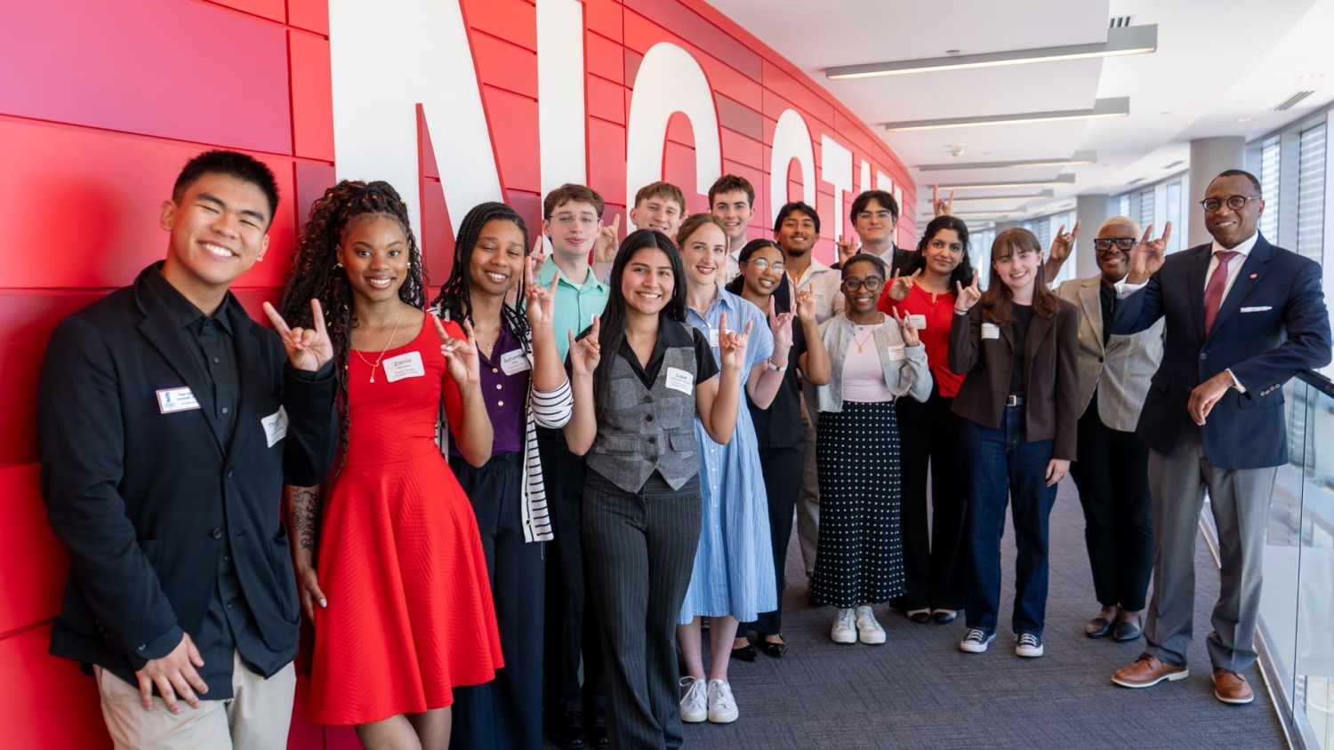 Students stand with wolfies with Chancellor Howell