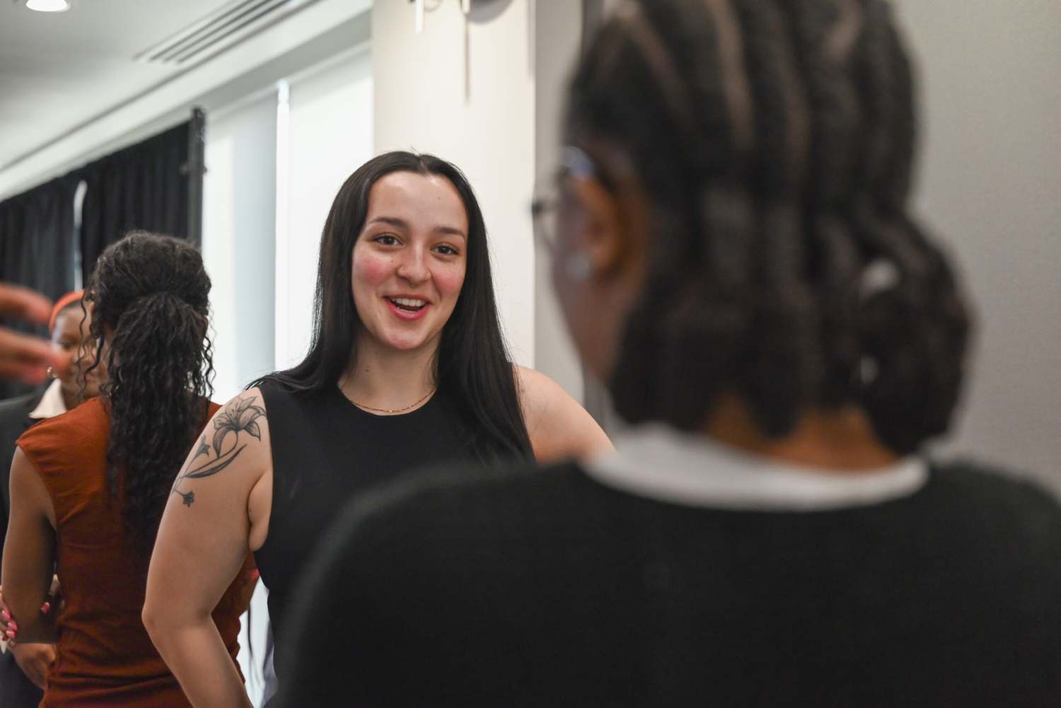Students engage in networking conversation with each other.