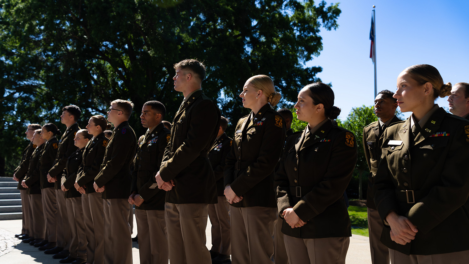NC State Army ROTC Cadets await their commissioning in front of the Memorial Bell Tower.