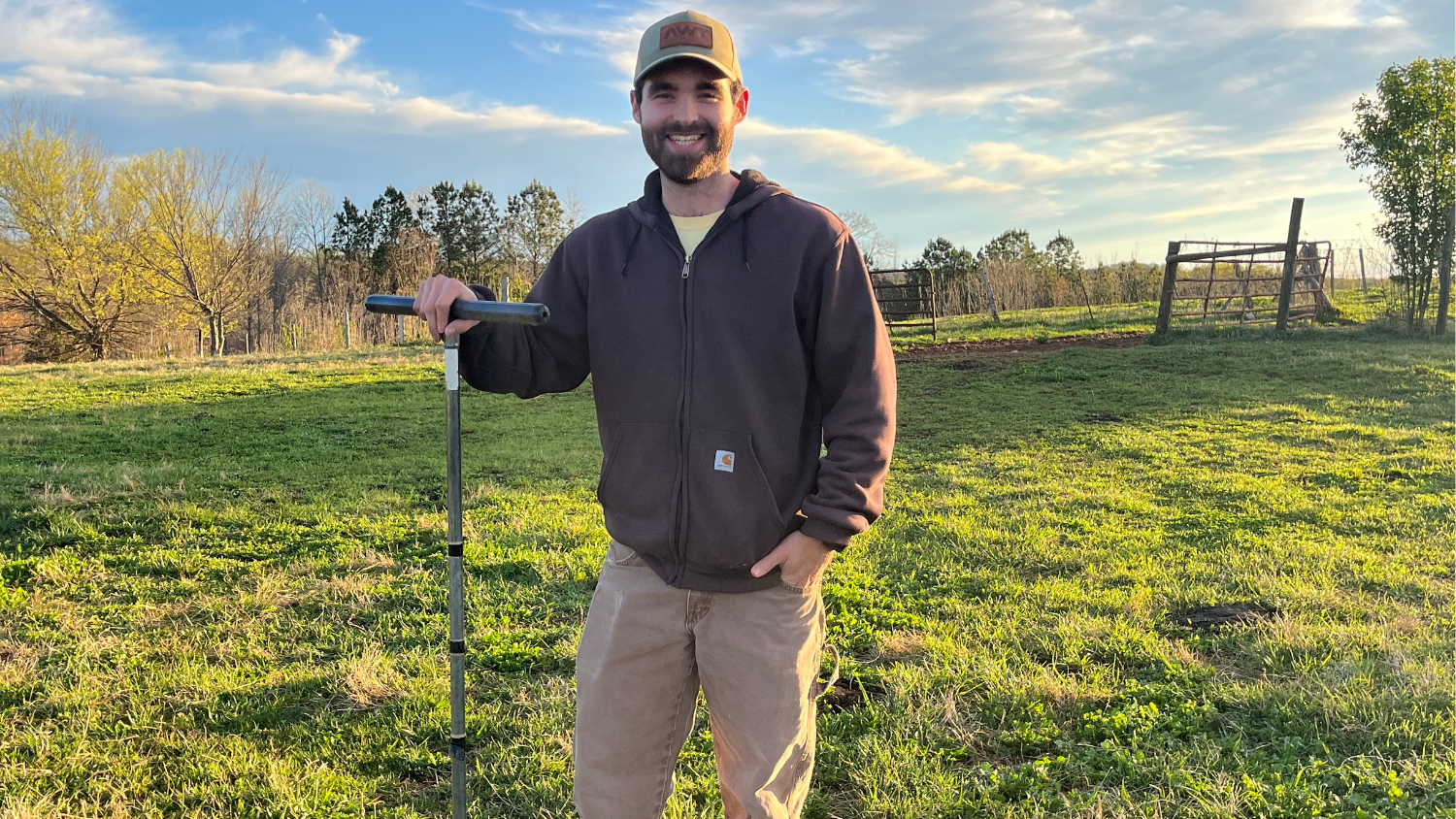 Noah stands in green field with equipment
