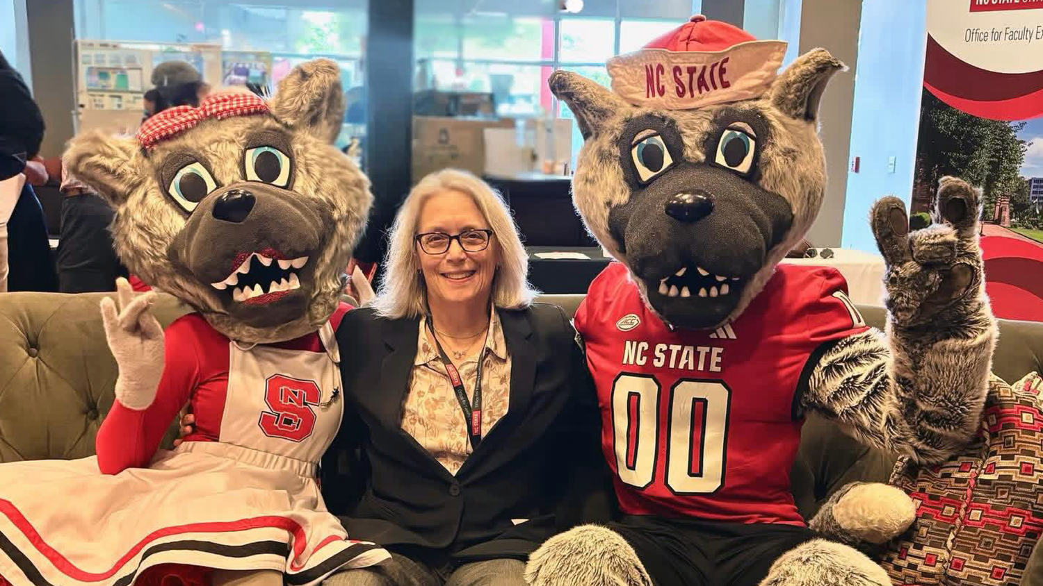 Diane Chapman sits on a couch between Mr. and Ms. Wuf.