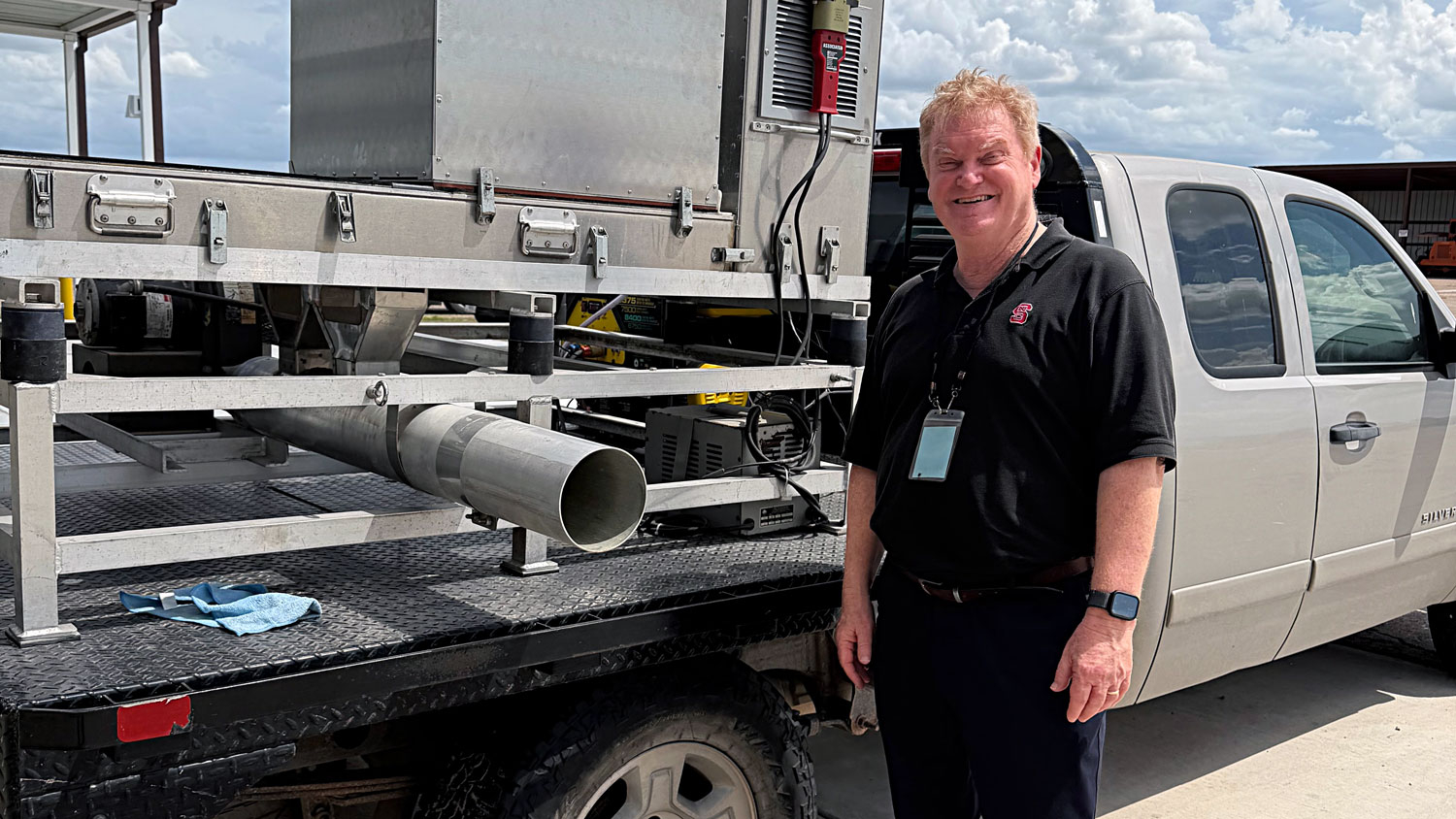 Scientist Max Scott stands in front of a vehicle used to distribute sterile male flies to suppress the spread of the New World screwworm.