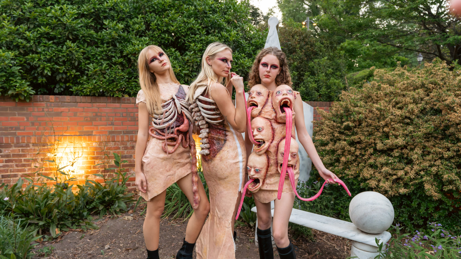 Three models pose outside wearing pieces from Aurora Henderson's collection, titled Heteropagus.