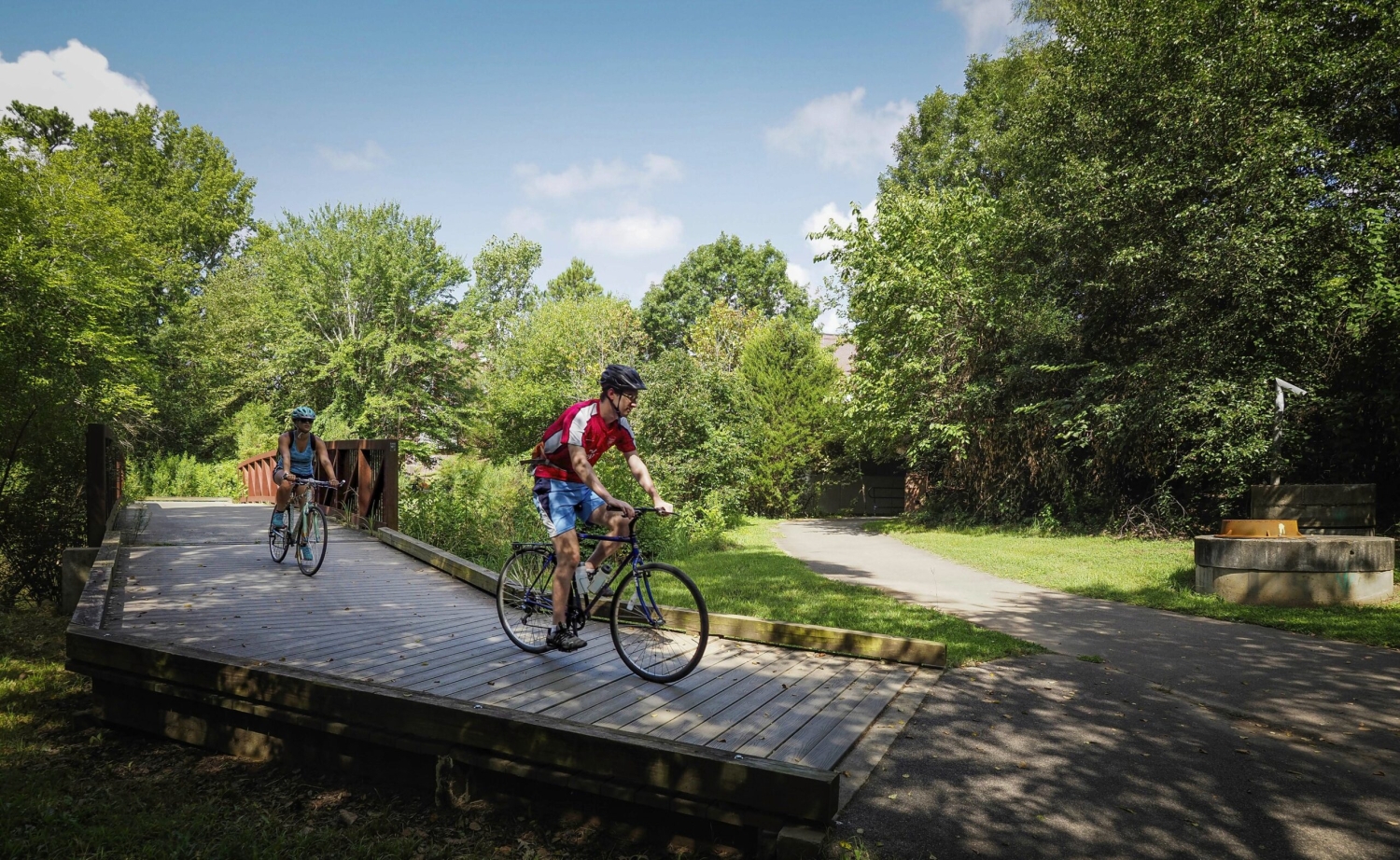 Cyclists pedal around Lake Raleigh on the greenway.