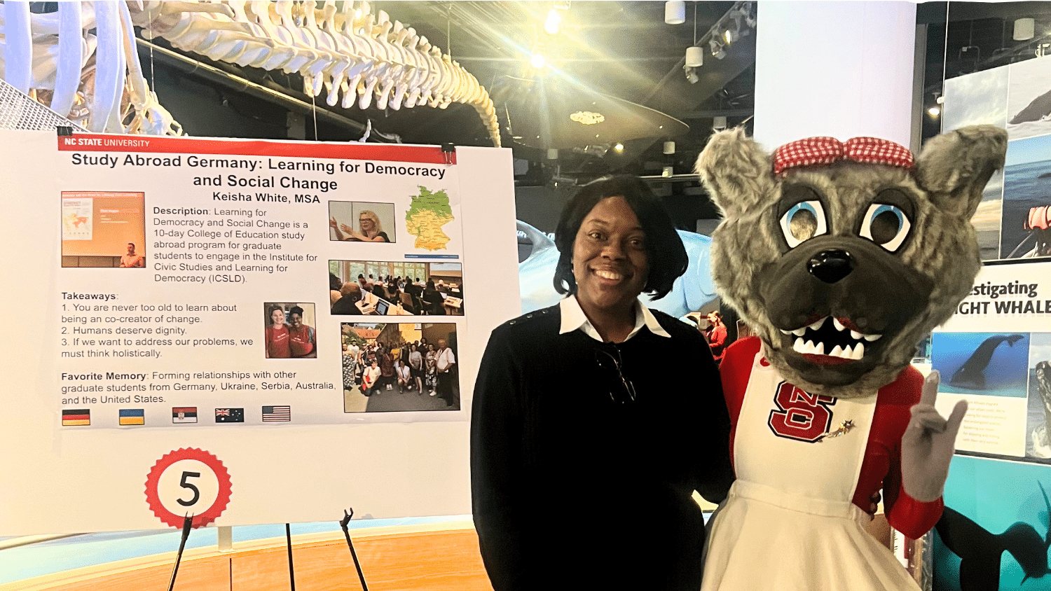 Keisha White with Ms. Wuf at the NC State College of Education High Impact Expo in December 2025.