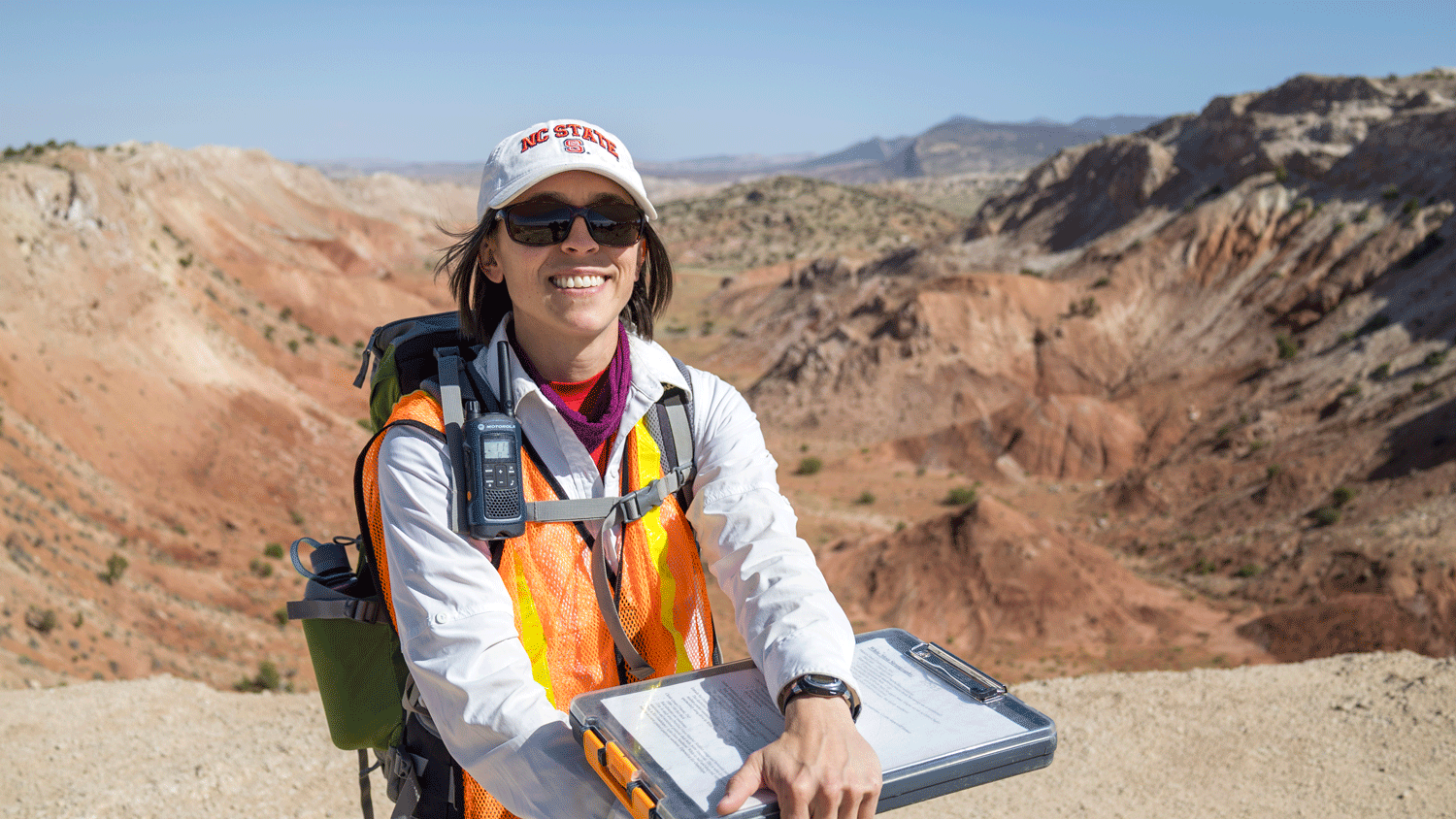 Geologist Maggie Ellis Curry stands in front of the deep valleys of White Mesa in New Mexico