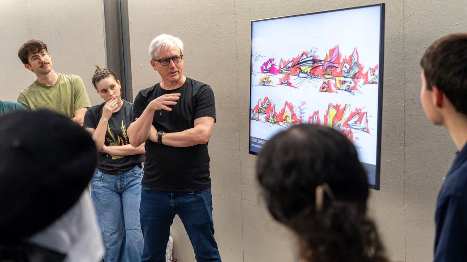 Ted Givens talks with students about his process.