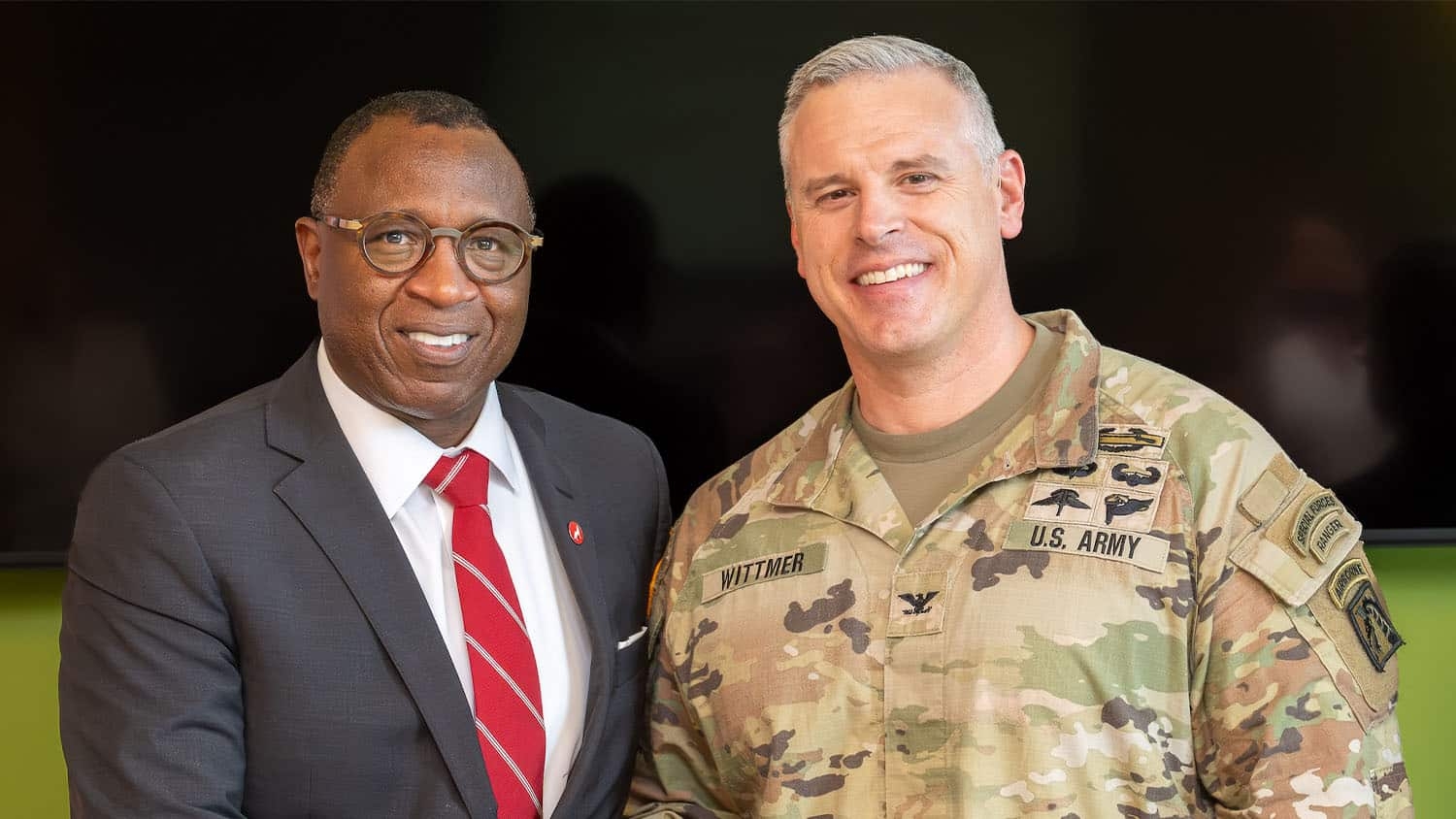 Chancellor Kevin Howell shakes hands with Colonel Luke Wittmer, Garrison Commander of Fort Bragg, at the Aug. 10 signing ceremony.
