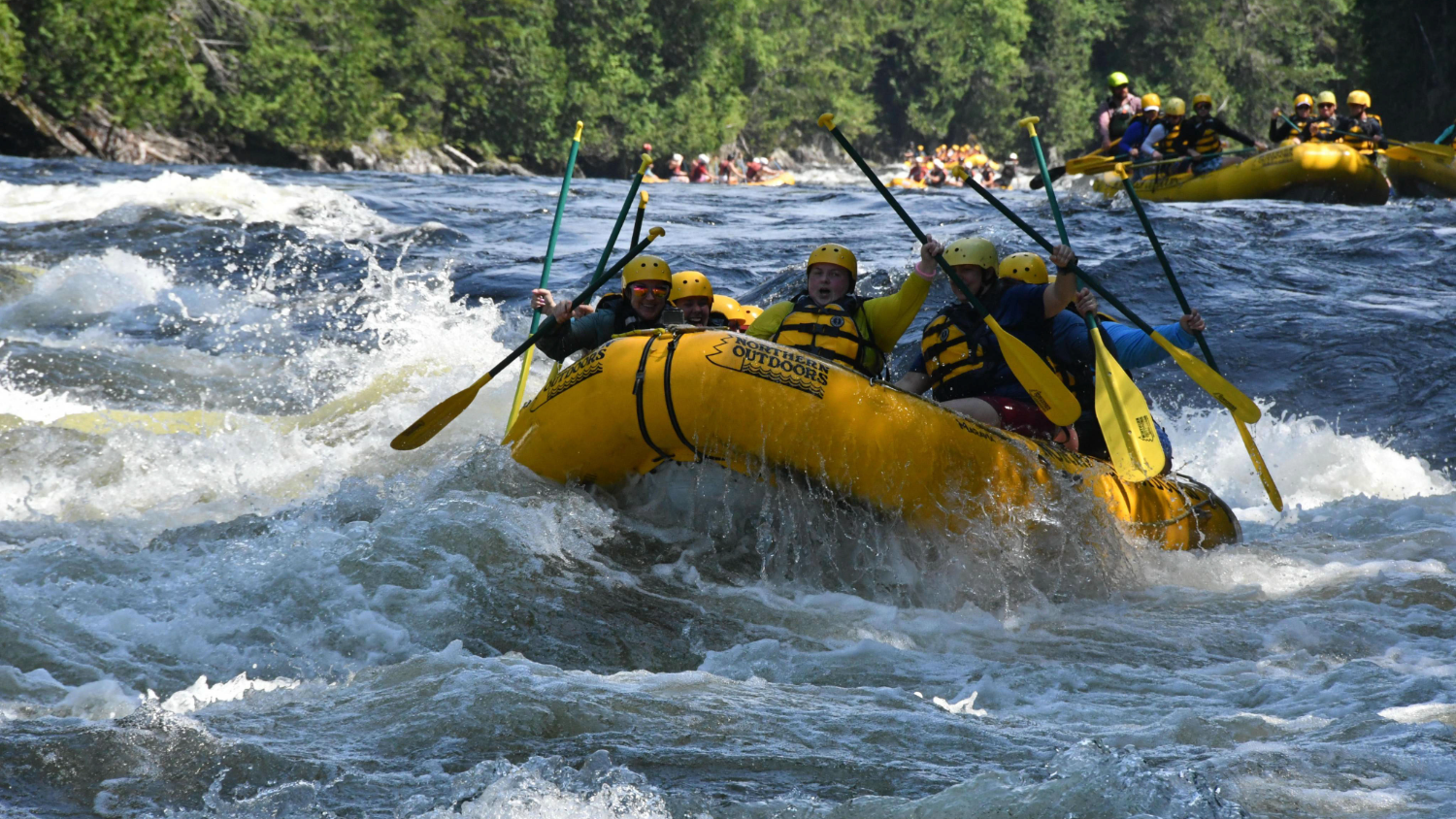 A raft tackles a wave.