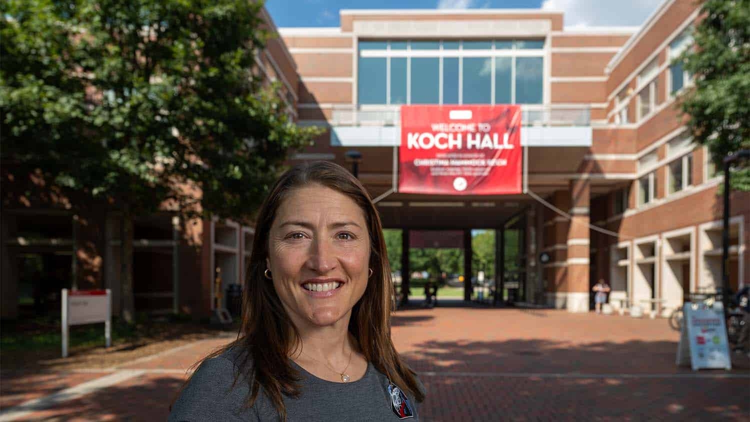 Christina Koch in front of the newly named Koch Hall on Centennial Campus.