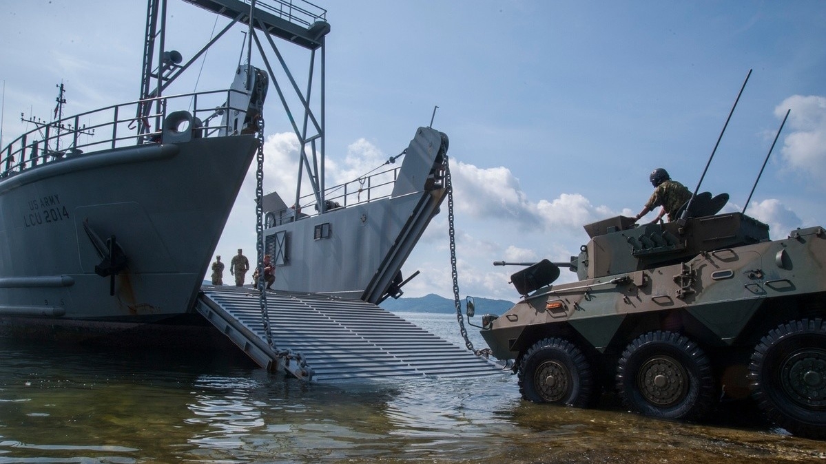 tank being loaded onto transport ship