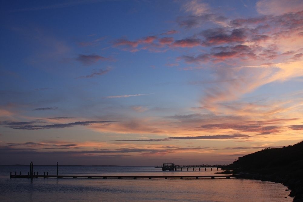 Blue, pink, and orange sunset with pier